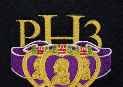 Detailed embroidered design on a polyester polo